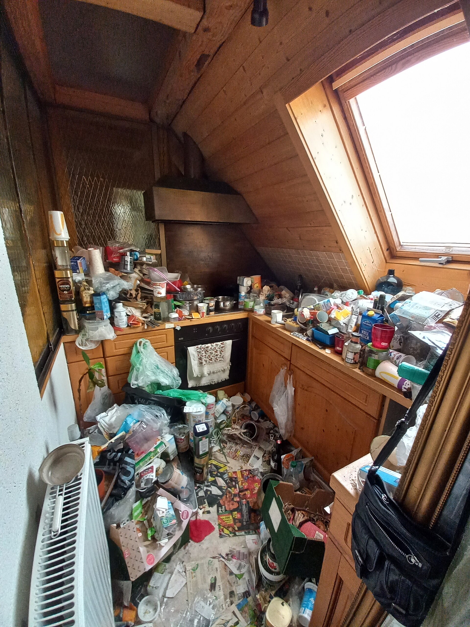 Before small kitchen example with crowded counters, bags, bottles, and no clear prep zone.